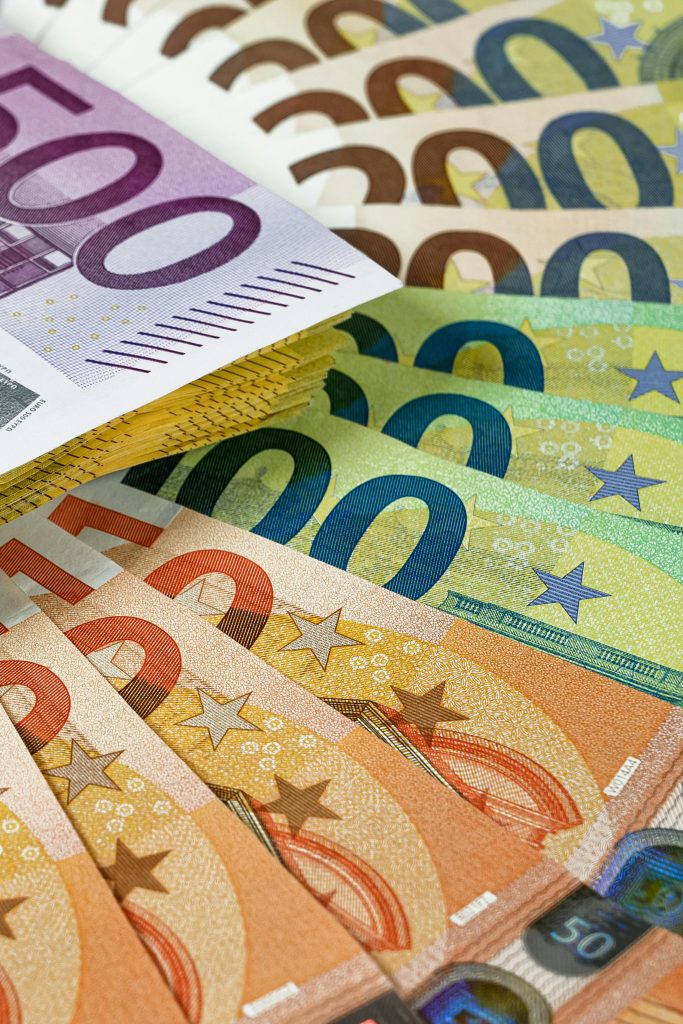 Close-up of various euro banknotes fanned out, showcasing colorful currency design.